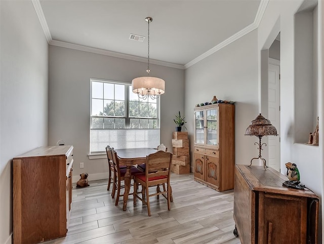 104 Rue De Montserrat, Norman, OK 73071 - dining space featuring ornamental molding, light wood-type flooring, an inviting chandelier, and visible vents