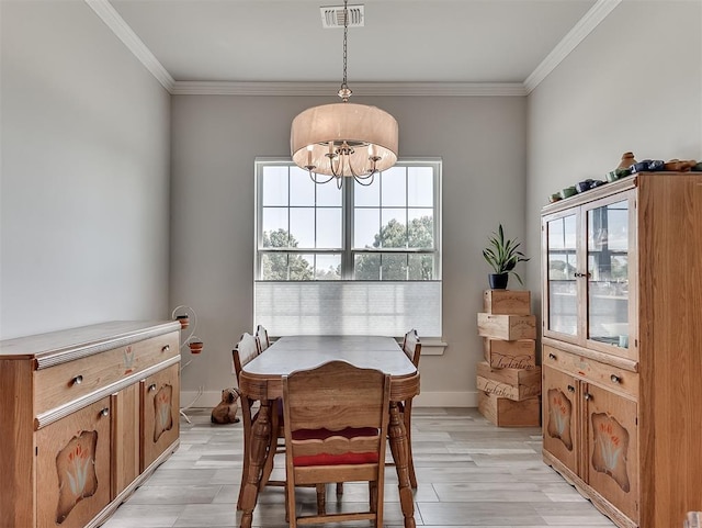 104 Rue De Montserrat, Norman, OK 73071 - dining space with light wood-style flooring, ornamental molding, visible vents, baseboards, and a notable chandelier