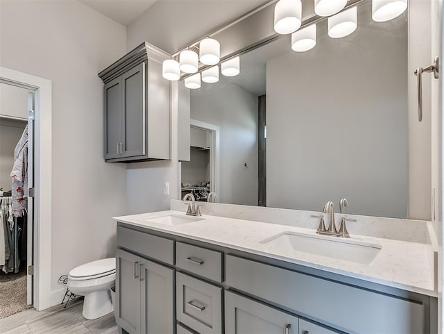 104 Rue De Montserrat, Norman, OK 73071 - full bath with a spacious closet, double vanity, a sink, and toilet