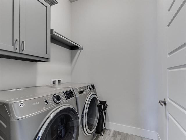 104 Rue De Montserrat, Norman, OK 73071 - clothes washing area with cabinet space, baseboards, separate washer and dryer, and light wood-style flooring