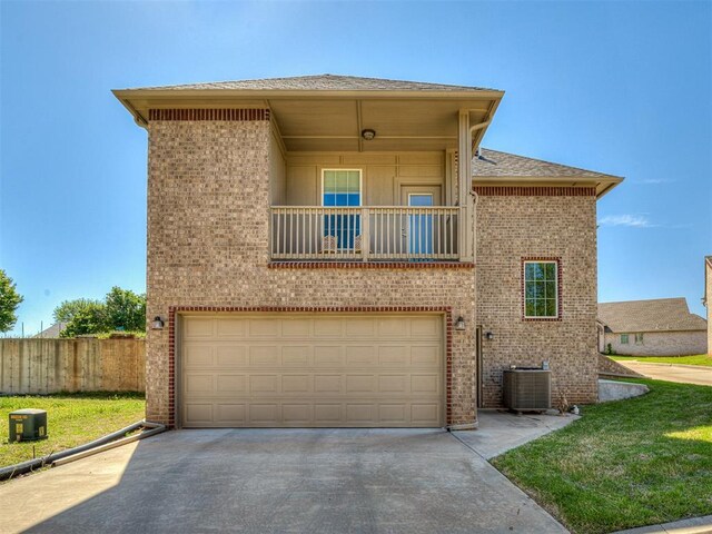 104 Rue De Montserrat, Norman, OK 73071 - view of front facade featuring a balcony, central air condition unit, driveway, an attached garage, and fence
