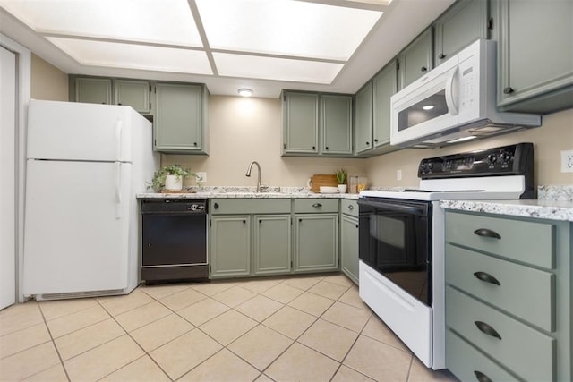 kitchen featuring a sink, light tile patterned flooring, white appliances, light stone countertops, and green cabinets