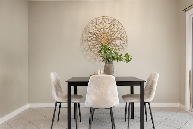 dining area featuring baseboards and light tile patterned flooring