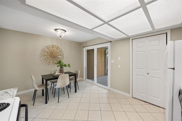 dining room featuring baseboards and light tile patterned flooring
