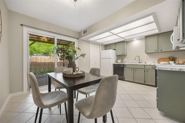 dining space featuring baseboards, light tile patterned flooring, a textured ceiling, and visible vents