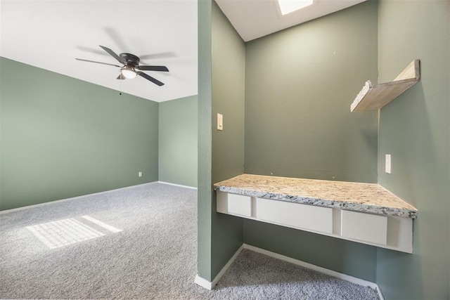 interior space featuring a ceiling fan and baseboards
