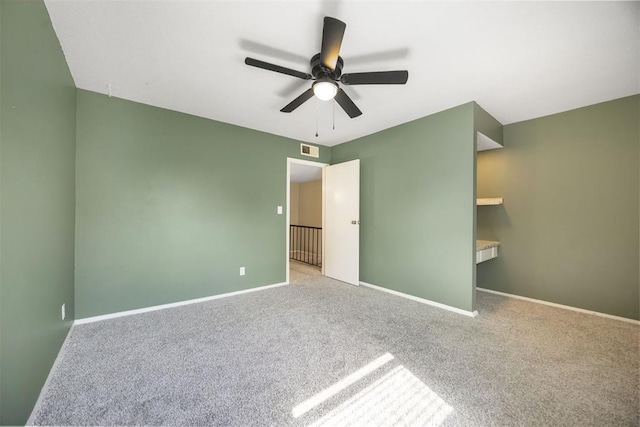 unfurnished bedroom with carpet, visible vents, baseboards, and ceiling fan