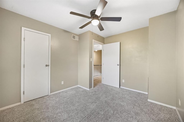 unfurnished bedroom with baseboards, a ceiling fan, visible vents, and carpet flooring