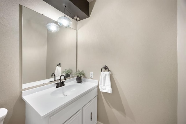 bathroom with toilet and vanity