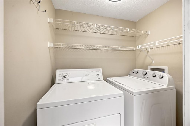 clothes washing area featuring washer and dryer and laundry area