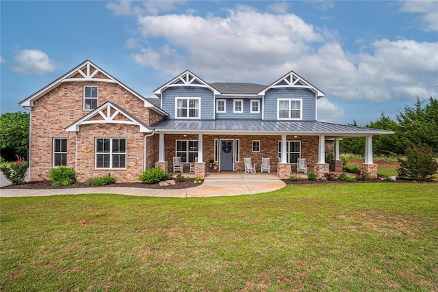 3441 Montilla Ct, Norman, OK 73071 - craftsman house featuring a standing seam roof, covered porch, a front lawn, brick siding, and metal roof