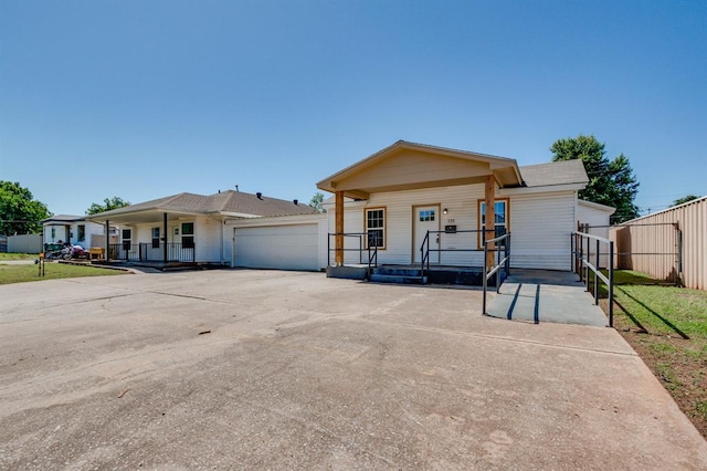 230 SE 50th St, Oklahoma City, OK 73129 - view of front facade with covered porch, driveway, and an attached garage