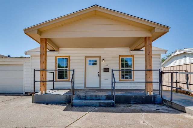 230 SE 50th St, Oklahoma City, OK 73129 - view of front of property with a porch, an attached garage, and driveway