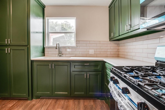 230 SE 50th St, Oklahoma City, OK 73129 - kitchen featuring green cabinetry, stainless steel appliances, light countertops, and wood finished floors