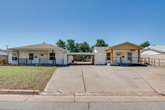 230 SE 50th St, Oklahoma City, OK 73129 - view of front of home with covered porch, concrete driveway, and a carport