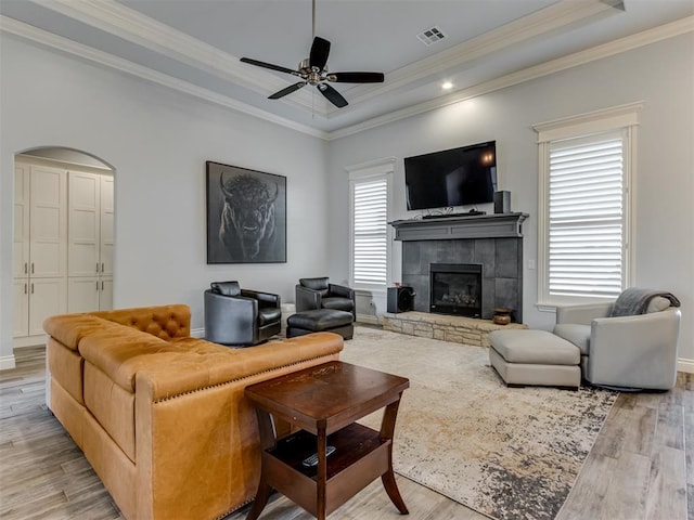3108 Drake Crest Dr, Edmond, OK 73034 - living area featuring a raised ceiling, visible vents, crown molding, and light wood-style floors
