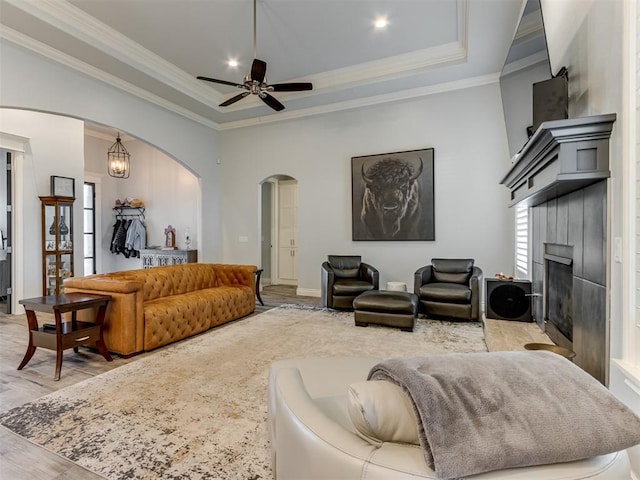 3108 Drake Crest Dr, Edmond, OK 73034 - living area with arched walkways, ceiling fan, crown molding, and a tray ceiling