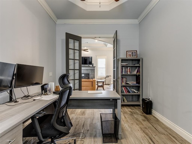 3108 Drake Crest Dr, Edmond, OK 73034 - office featuring crown molding, a ceiling fan, wood finished floors, and a fireplace