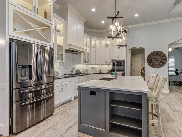 3108 Drake Crest Dr, Edmond, OK 73034 - kitchen featuring light stone counters, open shelves, white cabinets, a sink, and stainless steel appliances