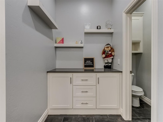 3108 Drake Crest Dr, Edmond, OK 73034 - bar with dark tile patterned floors and baseboards