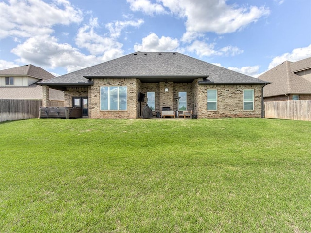 3108 Drake Crest Dr, Edmond, OK 73034 - back of property featuring a jacuzzi, a fenced backyard, and a yard