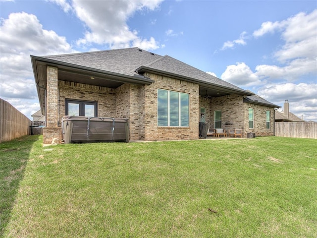 3108 Drake Crest Dr, Edmond, OK 73034 - rear view of property with brick siding, a fenced backyard, a hot tub, and roof with shingles