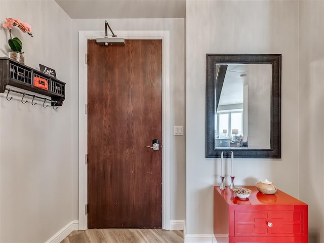 interior space with baseboards and wood finished floors