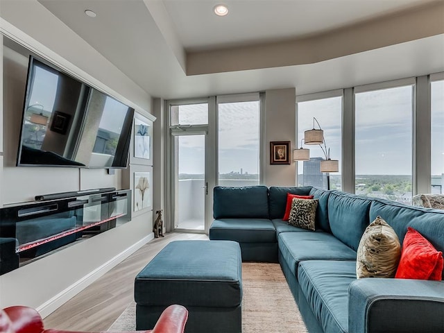 living area with recessed lighting, light wood-style flooring, and baseboards