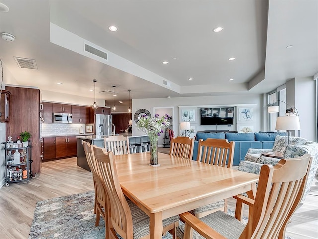 dining space featuring light wood-style floors, visible vents, and recessed lighting