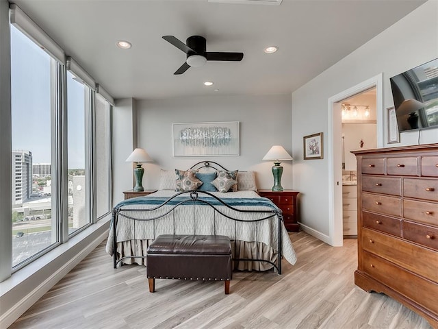 bedroom with light wood-style flooring, baseboards, recessed lighting, and multiple windows