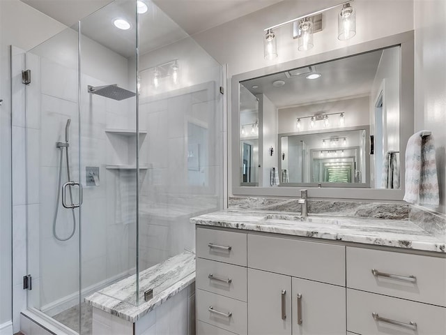 bathroom featuring a shower stall and vanity