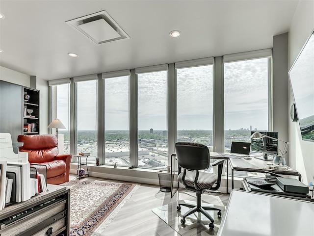 office space with a wealth of natural light, wood finished floors, and recessed lighting