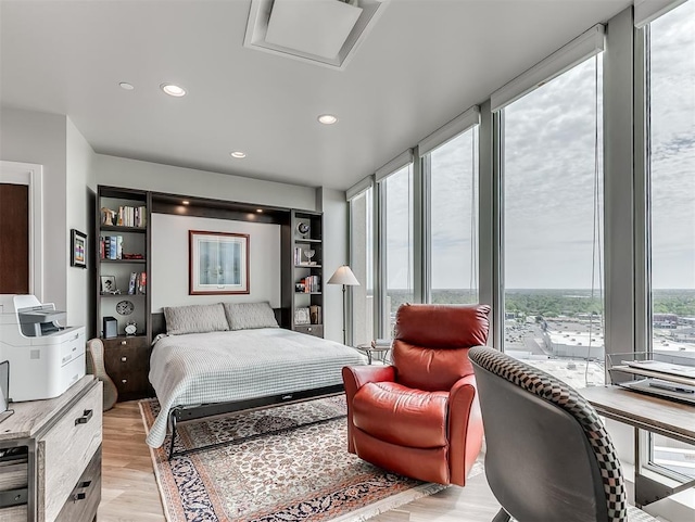 bedroom with light wood-type flooring and recessed lighting