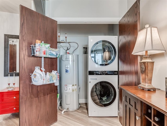 laundry room with water heater, stacked washer / drying machine, and light wood finished floors