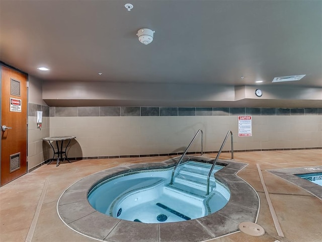 view of pool featuring an indoor in ground hot tub and a swimming pool