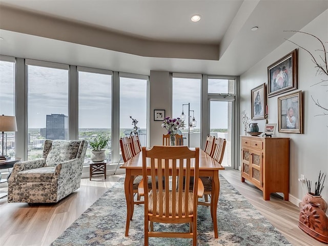 dining space featuring plenty of natural light, light wood-style flooring, baseboards, and recessed lighting