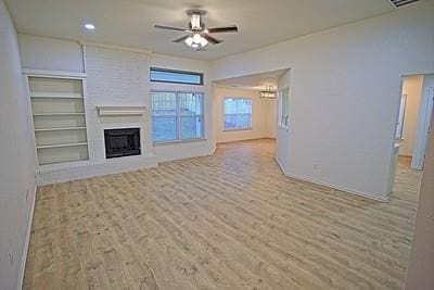 unfurnished living room with baseboards, recessed lighting, a fireplace, a ceiling fan, and wood finished floors