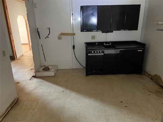 721 SW Blaine Ave, Geary, OK 73040 - kitchen with light floors, dark cabinetry, and a sink