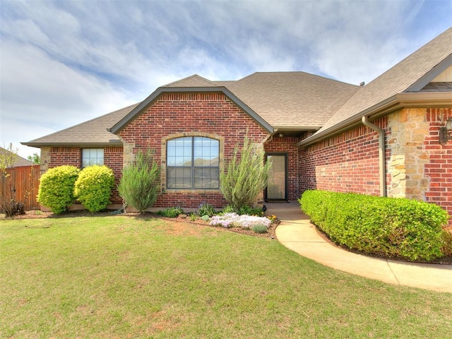 3515 Homesteaders Ln, Guthrie, OK 73044 - ranch-style home featuring brick siding, roof with shingles, a front lawn, and fence