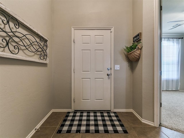 3515 Homesteaders Ln, Guthrie, OK 73044 - entryway featuring baseboards, visible vents, and dark tile patterned flooring