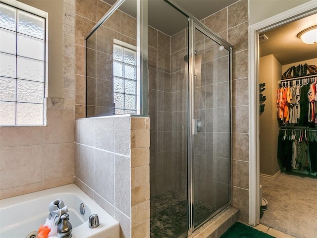 3515 Homesteaders Ln, Guthrie, OK 73044 - bathroom featuring a spacious closet, a wealth of natural light, and a stall shower