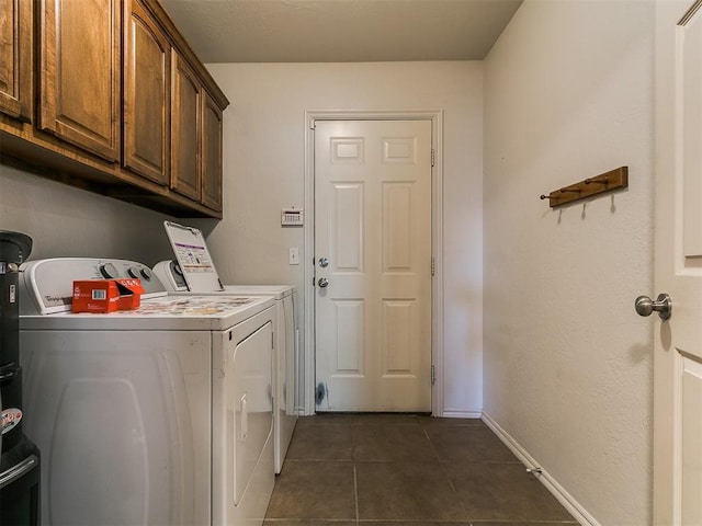 3515 Homesteaders Ln, Guthrie, OK 73044 - clothes washing area featuring dark tile patterned floors, baseboards, washer and clothes dryer, and cabinet space