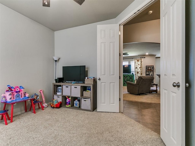 3515 Homesteaders Ln, Guthrie, OK 73044 - playroom with arched walkways, carpet flooring, ceiling fan, and tile patterned floors