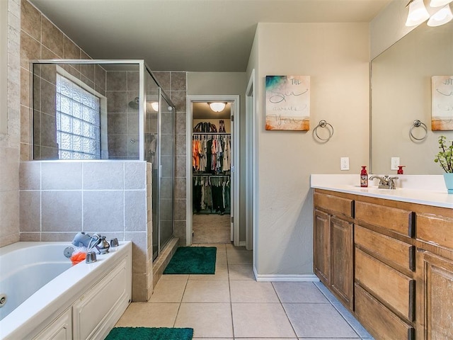 3515 Homesteaders Ln, Guthrie, OK 73044 - bathroom featuring a stall shower, a bath, a walk in closet, vanity, and tile patterned flooring