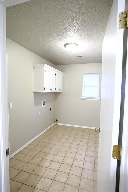 laundry room with hookup for an electric dryer, baseboards, a textured ceiling, washer hookup, and cabinet space