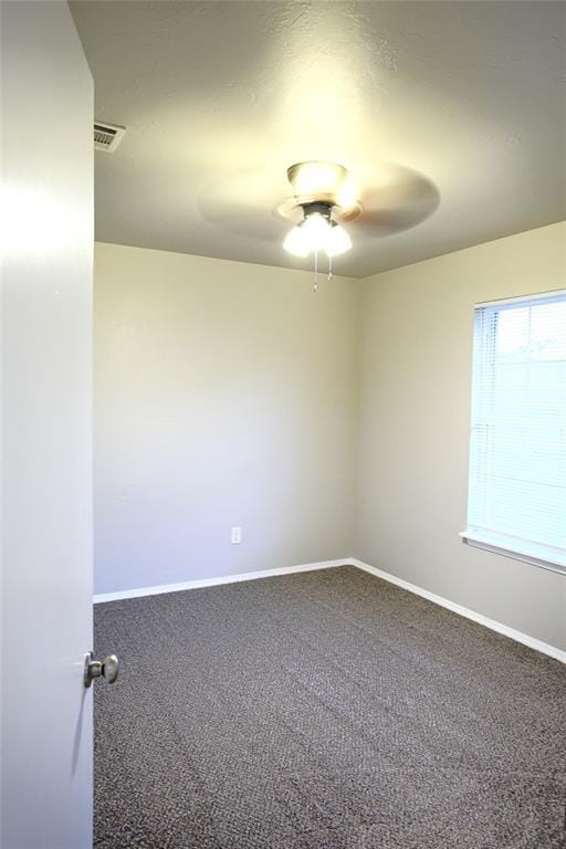 unfurnished room with carpet flooring, baseboards, and ceiling fan