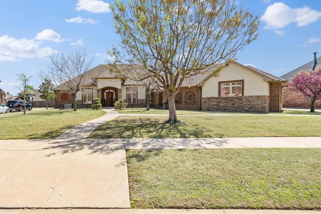 view of front facade with stucco siding, a front lawn, and stone siding
