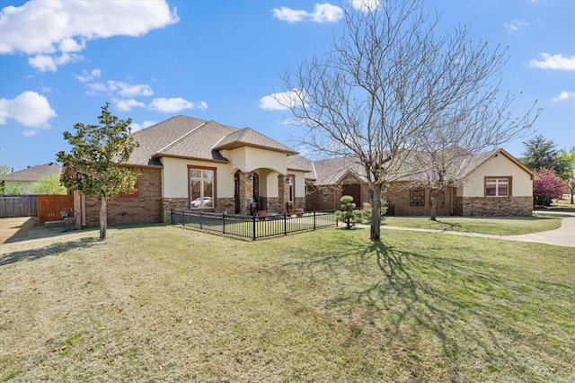 ranch-style house featuring stucco siding, a front lawn, fence, and stone siding