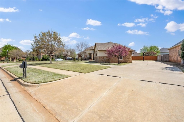 view of yard featuring fence and driveway
