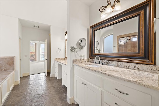 full bathroom with baseboards, visible vents, and vanity